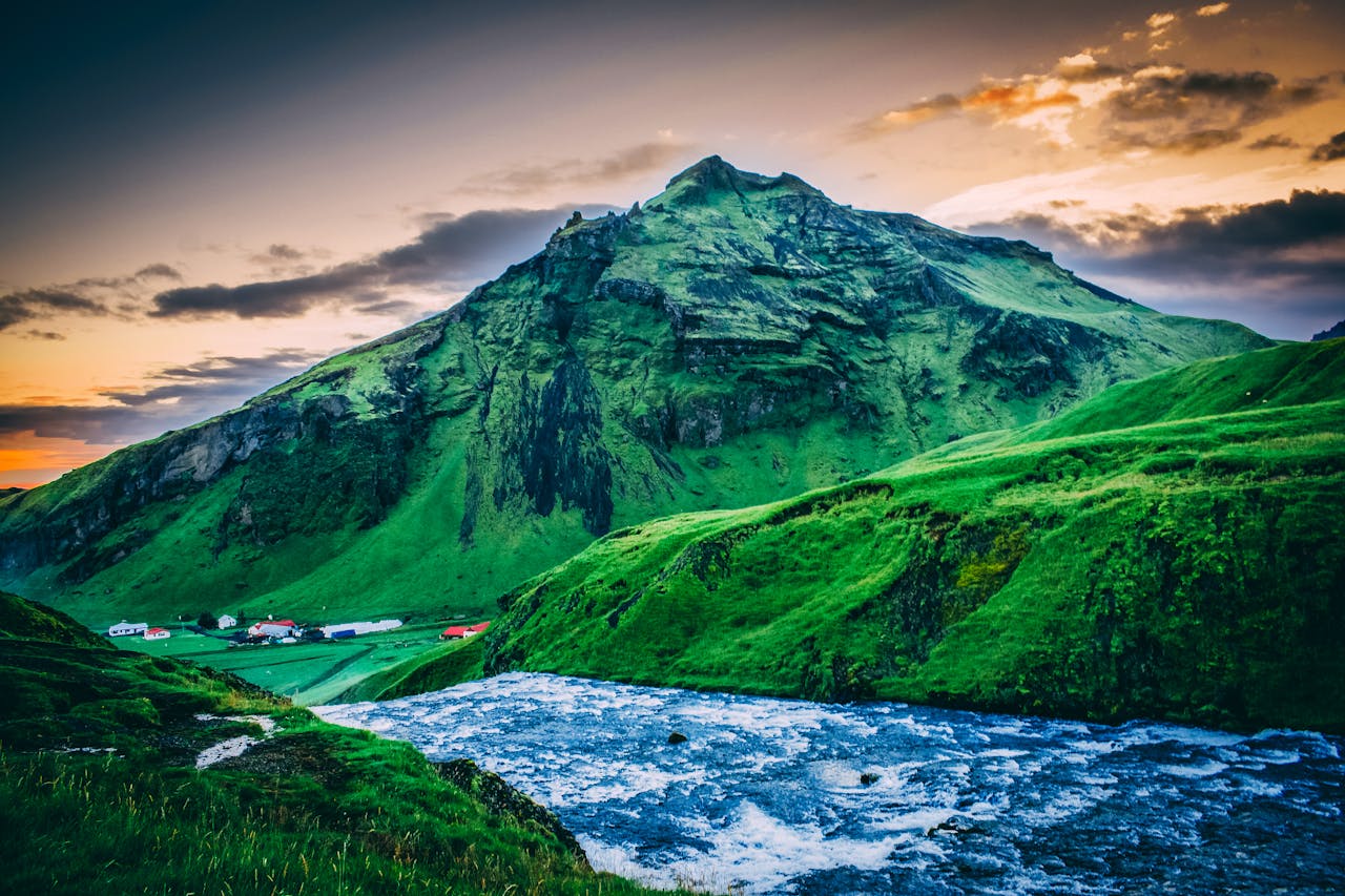 pexels-photo-831061 Experience the serene beauty of Iceland's mountains and rivers at sunset, offering a stunning natural landscape.